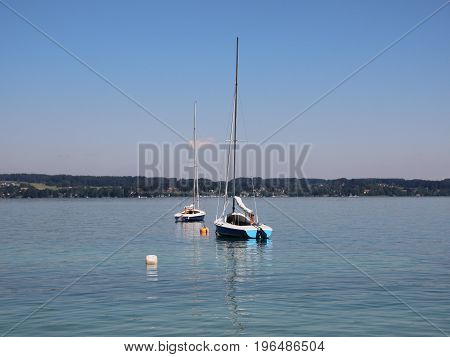 Sailing Boats on Blue Lake with Large Mountain Background in Summer