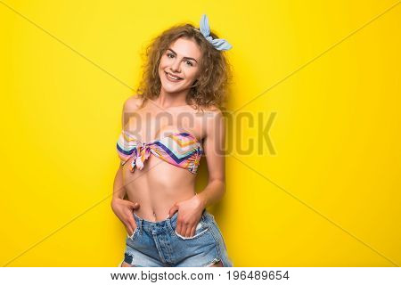 Young Beautiful Curly Woman With Happy Fency Mood On Yellow Background