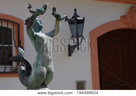 MAINZ, GERMANY - May 28: The fish fountain created by Elsa Montag in the Gau Street at the Court of Ostein with a mermaid sculpture on May 28 2017 in Mainz.