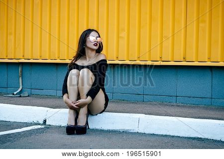Gorgeous Brunette Girl With A Beautiful Make-up In Fashionable Clothes: A Black Blouse And Shorts Wi