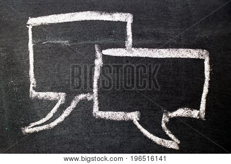White chalk drawing as bubble speech on black board background (Concept as online chat thinking talking with customer)
