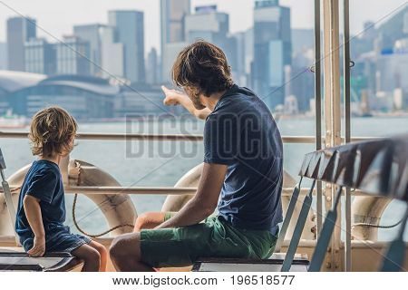 Father And Son Swim By Ferry Through Victoria Harbor In Hong Kong,china