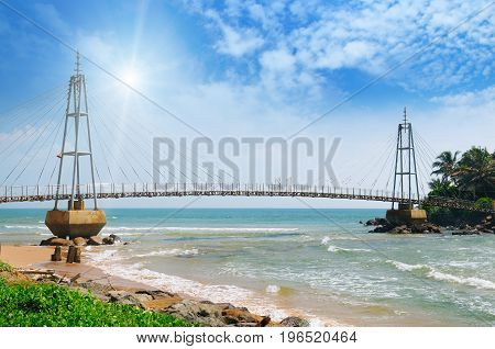 bridge to island ocean and sun in blue sky (Matara Sri Lanka)
