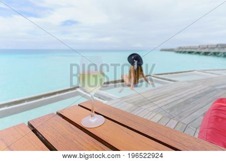 Cold glass of white wine in fantastic atmosphere at Maldive Island