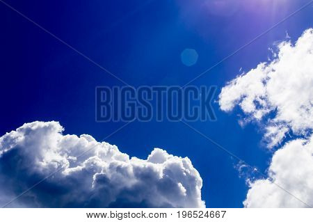 a big and fluffy cumulonimbus cloud in the blue sky.