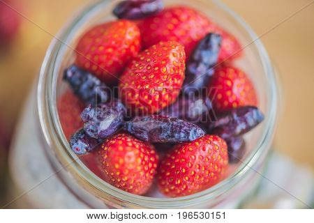 Wild Strawberries And Blue Honeysuckle Berries Wood Background