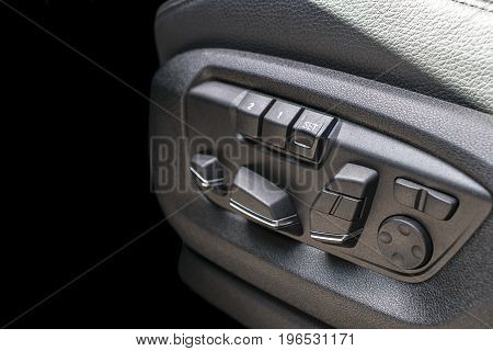 Power seat contol buttons of a passenger car modern car interior details