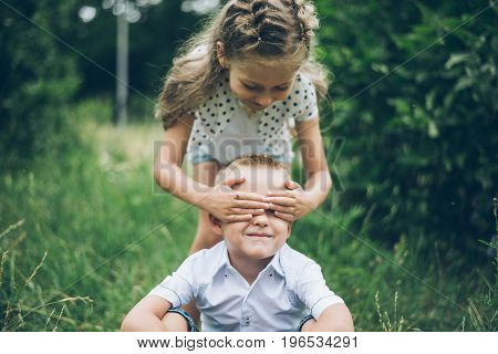 kids playing in the park, guess who, closing each other eye, siter and brother