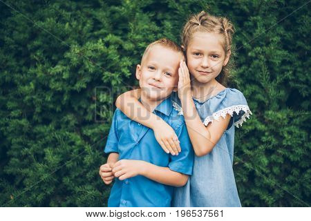 Grandmother playing in the park with grandchildren, siter with brother