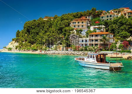 Typical mediterranean houses and fishing motorboat Makarska riviera Brela Dalmatia Croatia Europe