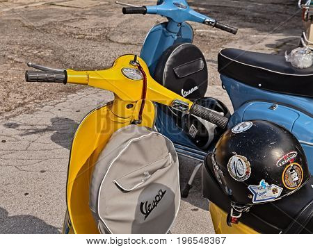 FORLIMPOPOLI, FC, ITALY - JUNE 19: yellow classic scooter Vespa with spare wheel cover parked during the italian scooter rally 