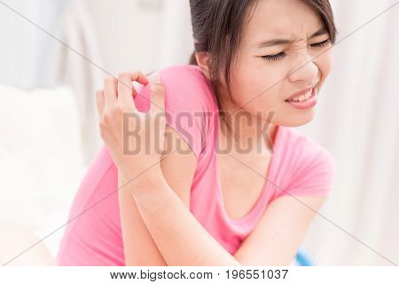 woman with itchy skin problem on the back in room