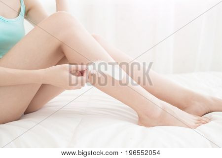 beauty woman with her leg in the bed room