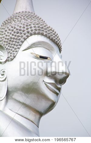 Close Up the face of The big silver buddha statue or Luang Phor Ngern statue at Wat Paknam Boong Sapang Ubonratchathani.