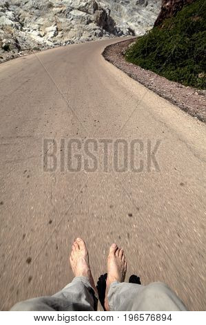 Human foot over the road Hormuz Island Hormozgan Province Iran.