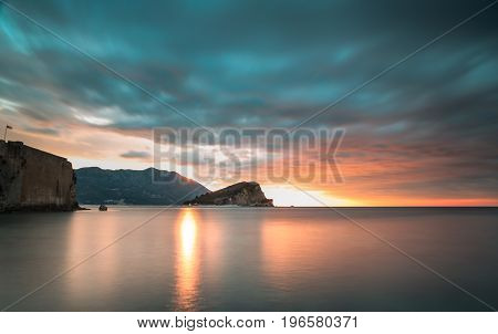 Clouds over the sea and the old city at sunrise