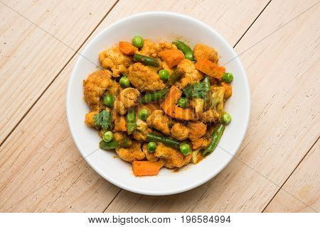 indian spicy food Gobi matar Masala or cauliflower curry with green peas or phool gobi fry, selective focus
