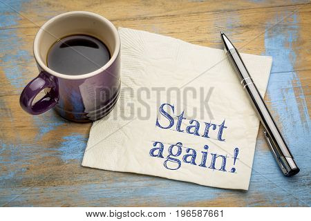 Start again motivational reminder or advice - handwriting on a napkin with a cup of espresso coffee