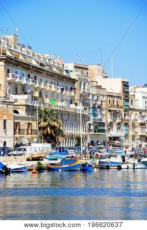 SENGLEA, MALTA - MARCH 31, 2017 - View of the Senglea waterfront with traditional Maltese Dghajsa water taxi boats moored in the harbour Vittoriosa Malta Europe, March 31, 2017.
