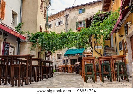 POREC, CROATIA - JULY, 14: Restaurant table in Porec street on July 14, 2017