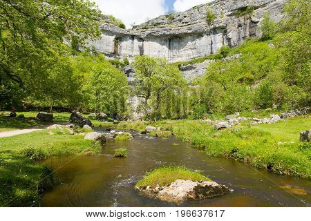 Malham Cove with the stream at the bottom of the rocks Yorkshire Dales National Park UK