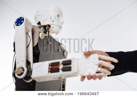 Polite machine. Scrupulous savvy devoted scientist checking the response system of elaborate machine while developing software for artificial intelligence