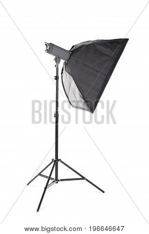 A professional studio softbox isolated over the white background. A dark saturated black softbox on a long metal tripod. Photographic equipment for photographers. Photo business.