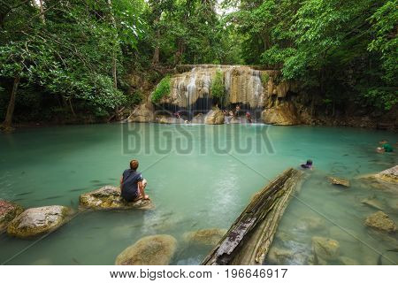 People Traveling And Bath In Erawan Waterfall, Thailand