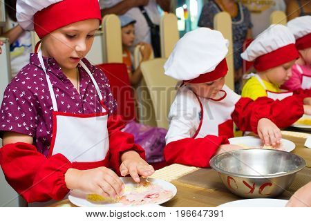 Alchevsk, Ukraine - July 23, 2017: School Cook For Children. Meat Rolls With Cheese Are Prepared.