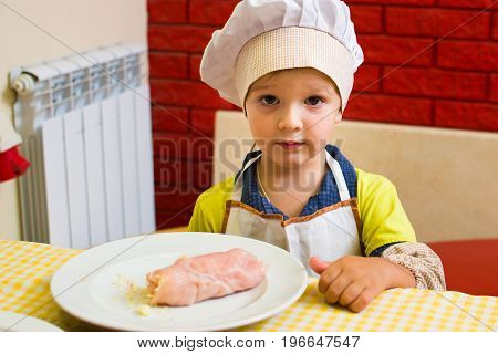 Alchevsk, Ukraine - July 23, 2017: School Cook For Children. Meat Rolls With Cheese Are Prepared.
