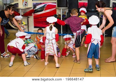 Alchevsk, Ukraine - July 23, 2017: School cook for children. Active games with children in the form of cooks.