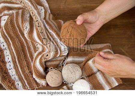 Knitting from natural wool closeup of the hands