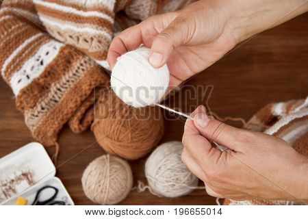 Knitting from natural wool closeup of the hands