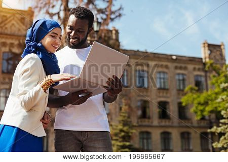 Adding some details. Charismatic talented capable lady meeting her fellow student at the university and helping him sorting the ideas he working on