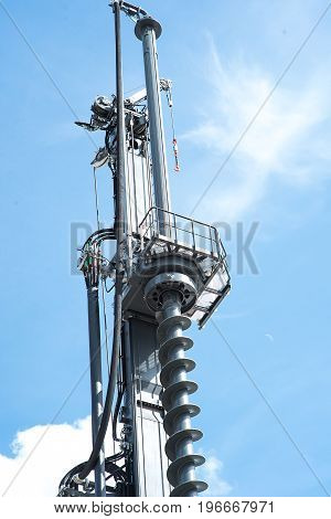 Hydraulic drilling rig in sky with clouds