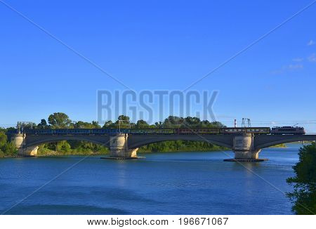 Passenger train on the railway bridge on the Rhone River between Tarascon and Beaucaire France