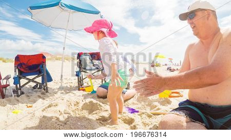Myrtle Beach South Carolina USA-July 11 2017. POV point of view - Summer vacation on the beach. Father and kids playing in the sand.