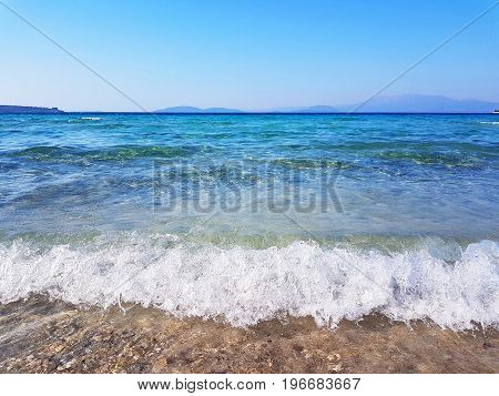 Seacoast of Cheshme Turkey. Blue seascape with light waves