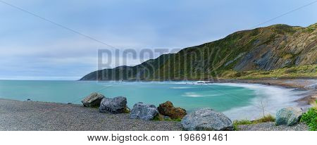 Panoramic image of Te Kopahou Reserve is located at Owhiro Bay where people can enjoy walking cycling and also driving 4WD vehicles along the coast Wellington North Island of New Zealand