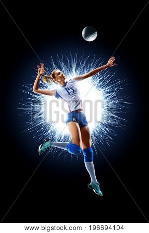Female professional volleyball player isolated on black background