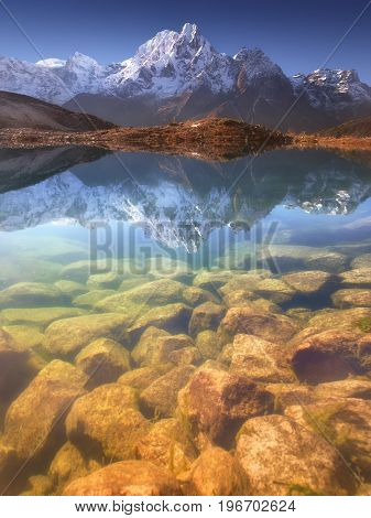 Nepal, Manaslu Region, a reflection in the Bimtang lake (3,680 m) of the Phungi peak (6,538 m) in the centre and the Mansiri Himal (7,059 m) at the left side.