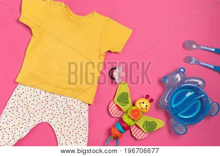 Baby clothes and accessories on pink background. Top view. Copy space. Still life. Flat lay