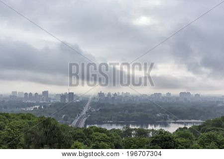 Foggy spring morning over Dnieper River left bank of the river is reflecting in the water.