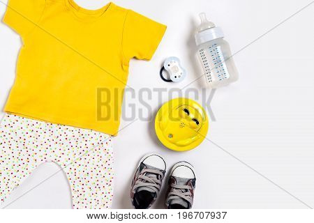Baby clothes and accessories on white background. Top view. Copy space. Still life. Flat lay