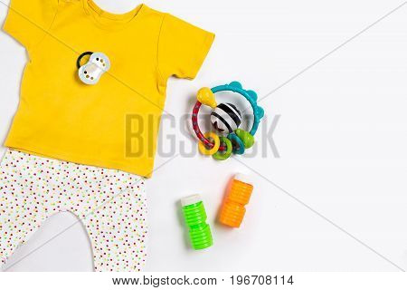 Baby clothes and accessories on white background. Top view. Copy space. Still life. Flat lay