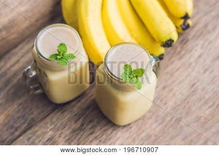 Banana Smoothies And Bananas On An Old Wooden Background