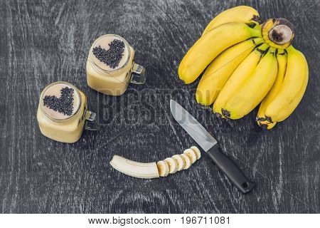 Banana Smoothies And Bananas On An Old Wooden Background