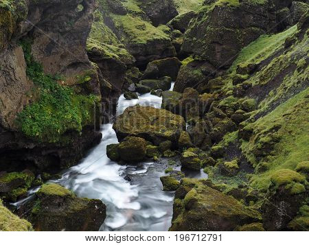 Blurry Water Stream In A Green Rocky Landscape In Iceland