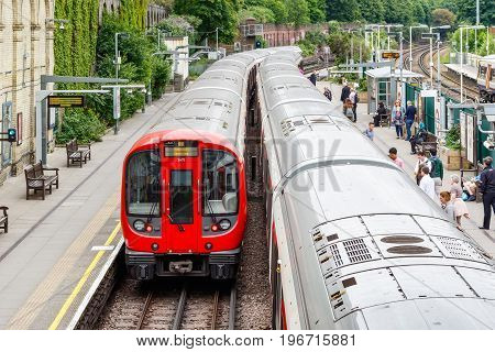 West Brompton Underground Station Platforms, With Commuters Boarding The Train