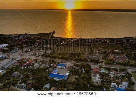 Sennoy, Russia - July 15, 2017: Beautiful colorful dramatic sunset sky over the silhouette of small town